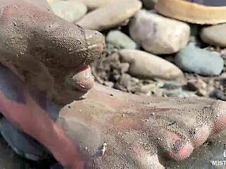 Goddess unveils messy nylon feet in torn pantyhose by river bank