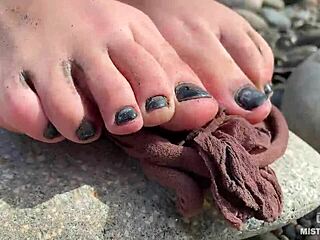 Goddess unveils messy nylon feet in torn pantyhose by river bank