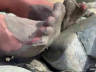 Goddess unveils messy nylon feet in torn pantyhose by river bank