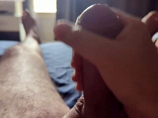 Sun rays filter through the window as he masturbates his big cock in the bedroom.