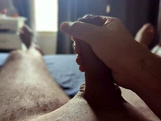 Sun rays filter through the window as he masturbates his big cock in the bedroom.