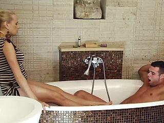 she starts a teasing striptease in the bathroom while her husband relaxes in the bath