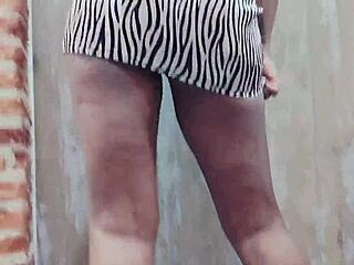 In the stripper club, the ebony woman danced and twerked, shaking her booty in a sexy dress.