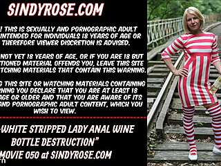 Whoa, check out this red-white stripped lady destroying her ass with a bottle outdoors