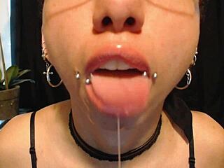 The cute goth teen puts on nude colored lipstick, letting saliva drip and drool all over her pretty wet tongue.