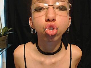 The cute goth teen puts on nude colored lipstick, letting saliva drip and drool all over her pretty wet tongue.