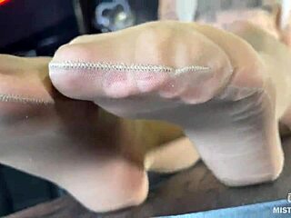 Beautiful feet of the mistress in flesh-colored tights tease you on the table close-up!