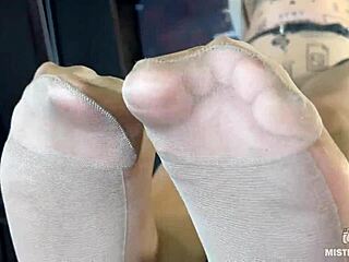 Beautiful feet of the mistress in flesh-colored tights tease you on the table close-up!