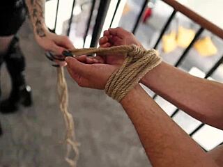 Latex-clad goth with long hair dominates in bedroom tie and tease scene with fishnets and fingering.