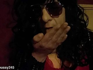 Bisexual crossdressing sissy indulges in homemade masturbation with fake tits, savoring cumshot taste licked from hand and smeared on face.