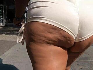 those tiny shorts barely hide her milf curves on the street