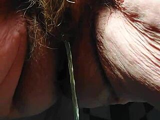 hey oma stuffs that cucumber deep in her hairy granny pussy