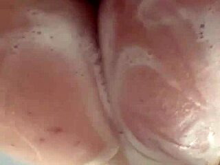 Horny British coed squirts toys in steamy shower solo