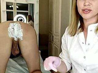 a beautiful babe trims her man's huge cock pubis and asshole smooth while he's bent over on all fours