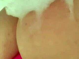 Horny British coed squirts toys in steamy shower solo