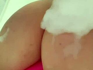 Horny British coed squirts toys in steamy shower solo