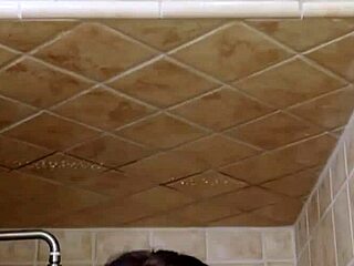 brunette fashion model steps under the shower for a quick rinse and refresh after her shoot