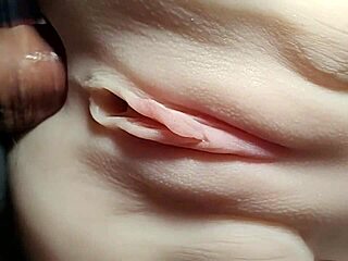 Close-up doll double penetration stretches shaved pussy wide