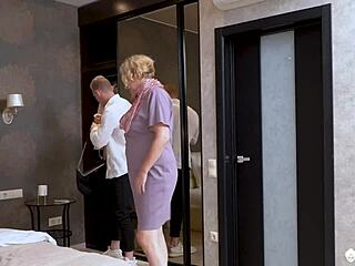 the sensual granny with glasses drops to her knees for a deep blowjob on agedlove bed