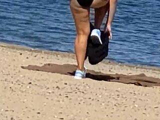 juicy asian teases on the beach in candid view