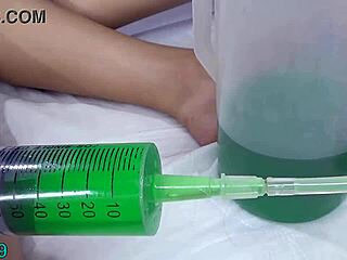 lesbian fills other uterus with piss using tube in peehole