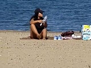 juicy asian teases on the beach in candid view