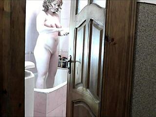 naked blonde in bathroom watches roommate stroke cock and cum